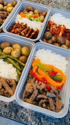 four trays filled with different types of food on top of a marble countertop