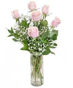 a vase filled with pink roses and baby's breath