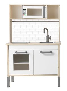 a white and wood play kitchen with sink