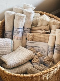 a wicker basket filled with towels and pillows