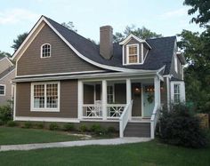 a brown house with white trim and windows