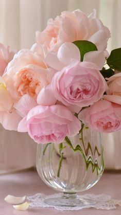 pink flowers in a glass vase on a table