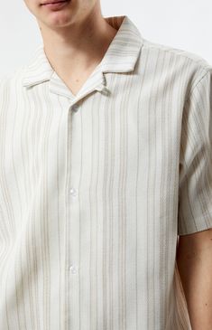 Step into summer with polished style in the Weave Stripe Woven Camp Shirt from PacSun. Featuring a collared neckline, short sleeves, and a regular fit, this shirt offers timeless sophistication. Complete with button closures and a woven striped pattern, it's the perfect choice for elevating your warm-weather wardrobe with ease.


	Collared neckline
	Short sleeves
	Button closures
	Regular fit
	Woven striped pattern
	76% Cotton, 15% acrylic, 8% polyester, 1% fibers
	Machine washable
	Model is wearing size medium
	Model Measurements: 6'1.5” Height, 28” Waist, 32” Inseam Leno Weave, Polished Style, Cream Shirt, Man Weave, Camp Shirt, Camping Shirt, Shirts For Men, Personal Marketing, Model Measurements