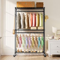 an iron rack with clothes hanging on it in a white room next to a dresser