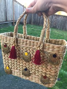 A lovely handmade open cane basket with beautiful trinkets and tassels. Carry it with you for your small beach accessories (sun screen, sun shades, hat, beach flip flops, etc.)  Or use it for your Easter eggs this time Or put in some different use. Multiple uses, pick your choice. Bag size: 11 inches x 8 inches x 3 inches Cane bag; Woven cane bag; Cane basket; Vintage cane bag; Cane accessories bag; Cane purse; Accessory bag; Beach purse; Beach bag; Easter basket; Cane Easter basket; Easter bag Bohemian Straw Tote Bag With Tassels, Bohemian Crochet Straw Bag, Handmade Straw Basket Bag, Bohemian Straw Bag With Tassels, Bohemian Straw Basket Bag With Braided Handles, Bohemian Brown Beach Bag For Gift, Bohemian Basket Straw Bag For Daily Use, Bohemian Straw Bag With Tassels For Daily Use, Brown Bohemian Straw Bag As Gift