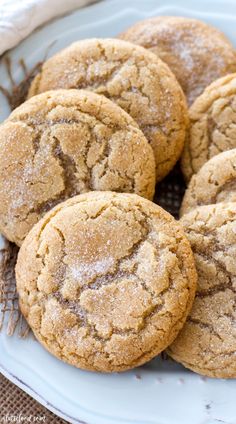 a white plate topped with cookies on top of a table next to a cloth bag