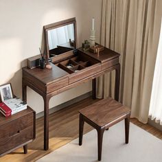 a dressing table with a mirror and stool in front of it on a wooden floor