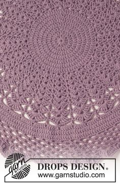 a purple crocheted bag sitting on top of a table