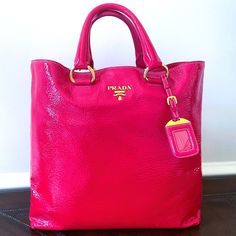 Authentic Prada Naplak Patent Leather Hot Pink City Shopper Tote Bag Retail: $1,990 Style: Bn1713 Material: Naplak Patent Leather Color: Fuxia (Hot Pink) Condition: Never Worn When You Carry This Prada Creation, Be Ready To Catch Admiring Glances As This Tote Is Stylish And Handy. It Has Been Crafted From Glossy Crinkled Patent Leather In A Gorgeous Hot Pink Shade With Rich Gold Hardware. The Tote Is Equipped With Two Leather Handles, A Removable Shoulder Strap, And A Very Spacious Nylon Interio Hot Pink Shopping Bags, Pink Sparkly Prada Bag, Hot Pink Prada Bag, Hot Pink Tote Bag, Pink Tote Shoulder Bag With Branded Hardware, Pink City, Pink Shade, Shopper Tote, Leather Handles