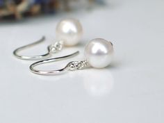 "Gleaming, white freshwater pearls dangling from sterling silver French ( or Leverback ) ear wires. Classic 7mm near round pearls with high luster and smooth surface. Simply elegant pearl earrings, great for everyday wear as well. Pearls are approx. 7 - 7.15mm, near round, with high luster and smooth surface ( minor natural imperfection ). - Earrings measure 13/16\" ( 2.1 cm ) with French Ear wires, and just over1\" ( 2.6cm ) with leverbacks. ✤ Earrings in 14k gold filled: https://www.etsy.com/l Adjustable White Pearl Earrings For Anniversary, Classic White Pearl Earrings For Bridesmaid Gift, White Pearl Earrings For Wedding With Lever Back, White Round Pearl Earrings For Bridesmaid Gift, Classic Nickel-free Pearl Earrings For Wedding, Rose Gold Pearl, Ivory Earrings, Simple Pearl, Gold Pearl Earrings