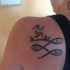 a woman with a tattoo on her shoulder that reads 2013 and has an image of a snake coming out of it