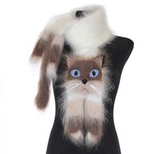 a black mannequin with a cat on it's head and blue eyes