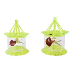 two small plastic bird feeders sitting on top of each other