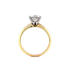 a yellow and white gold ring with a single diamond