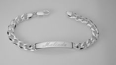 "This solid sterling silver bracelet is 8\" long and features a flat, diamond cut curb chain with a lobster claw clasp. The engravable identification plate is about 1.5\" long and a bit over .25\" wide and about 1/8\" thick. This is a heavy bracelet, weighing about 32 g. It has a high polish, shiny finish These look fabulous with a name, initials, a date or even Roman numerals. Delivered to you in a gift box. To see my current selection of bracelets: https://www.etsy.com/shop/AnniesHours?section Silver Hallmarked Nameplate Jewelry, Classic Adjustable Curb Chain Jewelry, Classic Engraved White Gold Chain Bracelet, Silver Adjustable Nameplate Jewelry, Adjustable Silver Nameplate Jewelry, Classic Engraved Link Chain Bracelet, Gift Sterling Silver Link Bracelet With Polished Finish, Elegant Personalized Curb Chain Jewelry, Anniversary Hallmarked Link Chain Bracelet