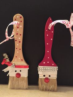 two brooms decorated with red and white polka dots, one has a face on it