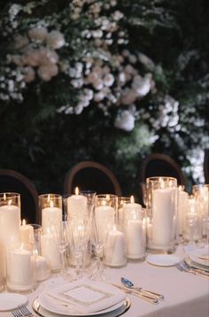 the table is set with candles and place settings