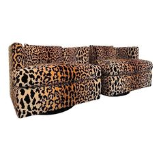 an animal print couch sitting on top of a white floor