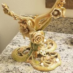 an ornately decorated candle holder on a marble counter