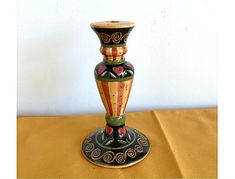 a vase sitting on top of a wooden table