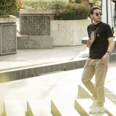 a man standing on some steps with his skateboard