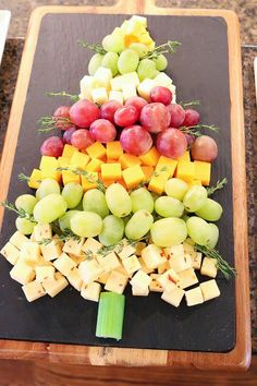 a christmas tree made out of cheese and grapes