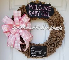 a welcome baby girl wreath on the front door