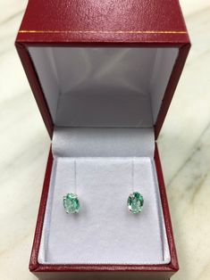 Featured here is a stunning set of oval Colombian emerald martini studs in fine .925 sterling silver. Displayed are light-green emerald with incredible transparency, accented by a simple four-prong silver mount, allowing for the emerald to be shown in full view. The earth mined, green Colombian emeralds have a desirable lush green color with excellent qualities. These earrings are ideal for everyday use and are the perfect accessory to any outfit. Approx Total Carat Weight: 1.0-carats Setting St Fine Jewelry Oval Earrings With Brilliant Cut, Gia Certified Oval Emerald Gemstone, Oval Birthstone Earrings For Formal Occasions, Gia Certified Oval Emerald, Oval Brilliant Cut Gemstones For Fine Jewelry, Oval Gemstones With Prong Setting For Gift, Gia Certified Oval Gemstones For Fine Jewelry, Oval Brilliant Cut Emerald Gemstones, Oval Diamond For May Birthstone