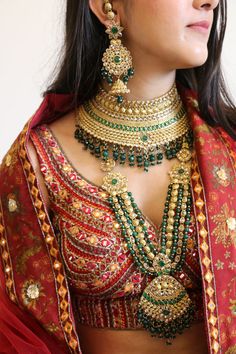 Emerald green kundan necklace set in high quality for the beautiful bride! This glamorous bridal set features shimmering faux kundan stones intricately decorated with emerald beads embellishments. The set comprises of 9 pcs including a long necklace, a princess necklace, a pair of beautiful  earrings with kaan chains, a mathapatti, a tika,a nose ring and a pair of haathphool. Details: Long Necklace Length-15.25 Inches Princess Necklace Width-4 Inches   Earrings Length-4.25 Inches Kaanchain Lengt Green Kundan Bridal Necklace Hand Set, Bollywood Style Green Kundan Necklace With Stone Work, Green Kundan Traditional Wear With Stone Work, Green Kundan Bridal Necklace With Stone Work, Bollywood Bridal Necklace, Green For Diwali, Green Kundan Chandbalis For Wedding, Wedding Jewelry With Meenakari And Emerald, Bollywood Green Bridal Necklace For Diwali, Heavy Green Kundan Chandbalis