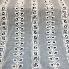 an image of a table cloth with blue and white laces on the edges,