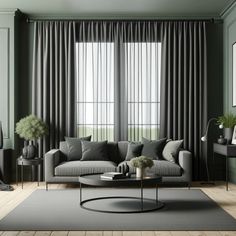 a living room with green walls and grey curtains on the windowsills, a gray couch in front of a round coffee table