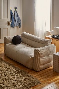 a couch sitting on top of a hard wood floor