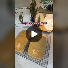 two loaves of bread sitting on top of a cooling rack next to pine cones