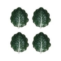 four green leaf shaped plates on a white background