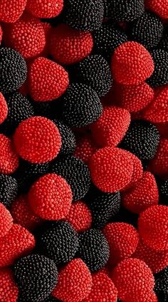 red and black raspberries are stacked together