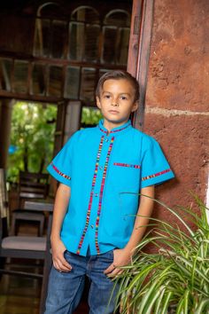 This traditional Mexican shirt otherwise known as Guayabera is a shirt that will never go out of style. It is stylish, fresh and comfortable. This elegant button up Shirt is perfect for every day use or a special occasion. Shop more kids clothing here: https://www.etsy.com/es/shop/SoleiEthnic?ref=seller-platform-mcnav&section_id=25467858 Traditional Cotton Shirt For Festivals, Traditional Stand Collar Top With Buttons, Casual Cotton Shirt With Traditional Patterns, Traditional Multicolor Cotton Shirt, Traditional Cotton Festival Shirt, Traditional Cotton Top With Stand Collar, Traditional Cotton Camp Shirt With Short Sleeves, Traditional Blue Shirt For Summer, Traditional Blue Summer Shirt