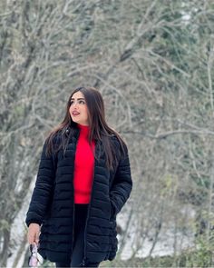 a woman walking her dog in the snow