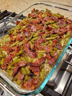 a casserole dish filled with green beans and bacon