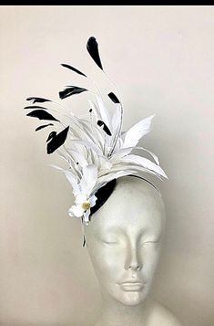 Feather Fascinator- Kentucky Derby- Mad Hatter- Wedding- Whimsical Headband- Cruella Hello, One of a kind. Ships in 1-2 business days.  This black and white feather headband is about 4" wide and has great movement.   Accented at the base with 3 white dogwood petals. A great headband for a wedding, special occasion, a day at the races or a 1920's party. -------------------------------------------------- To add a veil to this fascinator please purchase this also: https://www.etsy.com/your/shops/do Mad Hatter Wedding, 1920's Party, Black And White Feather, White Fascinator, 1920s Party, Wedding Whimsical, Day At The Races, Feather Fascinator, Feather Fascinators