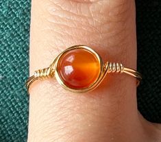 Handmade wire-wrap rings with real agate stone beads! This is my listing for rings with gold colored wire. Although each bead is unique, I have many general colors such as green, pink, orange, etc. Every single ring is made by me in my spare time as a college student! Thank you for your interest in my small business! :D Crystal Wrapped Rings, Simple Wire Rings, Uni Student, Diy Wire Jewelry Rings, Gold Wrap Ring, Wire Jewelry Rings, Wire Wrapped Stone Jewelry, Bijoux Fil Aluminium, Single Ring