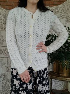 "Vintage knit sweater. Made by British Vogue Wintuk. White. Waves pattern. Buttons up front with pearl buttons. Long sleeves. Crew neck. 100% acrylic. (measurements taken flat) Label size: no size labeled (estimate small) Bust: 17\" Waist: 17\" Length: 25\" Shoulder width: 14.5\" Sleeve length: 26.5\" Excellent vintage condition. Some slight pilling, and one small, untreated stain on back (please see pictures). Otherwise no rips or snags." White Pointelle Knit Cardigan For Daywear, Classic Pointelle Knit Cardigan, Elegant Pointelle Knit Cardigan For Daywear, Classic Cream Cardigan With Pointelle Knit, Vintage Sweater For Spring Layering, Classic White Sweater With Buttons, Vintage Spring Sweater With Buttons, White Retro Sweater With Buttons, Retro White Sweater With Buttons