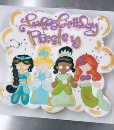 there is a birthday cake with princesses on it