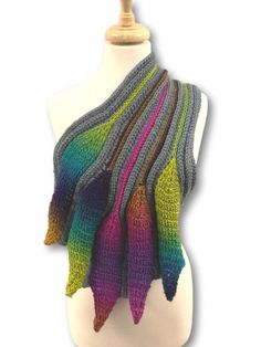 a multicolored knitted scarf on a mannequin