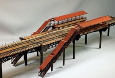 a model train set with multiple tracks and rails on top of each other in the shape of a bridge