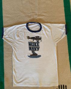 Nice vintage ringer t shirt, great graphics. Single stitch, tube knit (no side seams). Tags are faded but it is made in USA. One small hole in the back at the base of the collar. Measurements: 19 1/2 inches from pit to pit measured lying flat, 15 inches across the shoulders, the overall length is 26 1/2 inches. Looks like a cotton poly blend. Us Navy Sweatshirt, Navy Crewneck, Fringe Leather Jacket, Vintage Wrangler, Cool Jackets, Mens Graphic Tee, Vintage Denim, Vintage Tshirts, Made In Usa