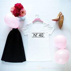 a t - shirt with the number 21 on it next to some balloons and shoes