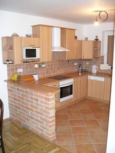 a kitchen with an oven, microwave and sink inside of it's center island