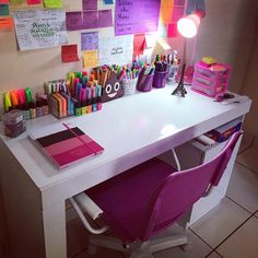 a white desk topped with lots of colorful markers