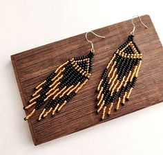 Gold black beaded earrings, Evening seed bead earrings, Long fringe earrings, Dangle black gold earrings, Native American earrings, Boho earrings, Native American jewelry, Beaded Jewelry, Beadwork jewelry, Tribal Ethnic style, dangle earrings, Gift for women, Tribal Ethnic earrings, handmade earrings Size:  Length: 2.4 inches   (6,8 cm) Width: 0.78 inches   (2 cm) Materials: czech seed beads Gold and black earrings. Very lightweight. Fusion between ethnic style and modern elements. Earrings made of quality Czech seed beads - black and gold colors  Cute handmade Earrings is a pleasant gift for you or for one you love. RECOMMENDATION FOR USE AND CARE:  - Do not clean with water and any other liquid. - Keep your handmade jewelry in a closed box far away from sun rays access. Thank you for you Shamrock Jewelry, Black Gold Earrings, Black Beaded Earrings, Irish Earrings, Sugar Skull Jewelry, Beadwork Ideas, Evening Necklace, Shamrock Earrings, Earrings Native American