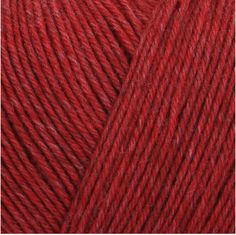 red yarn is shown in this close up shot, with the ball on the left side